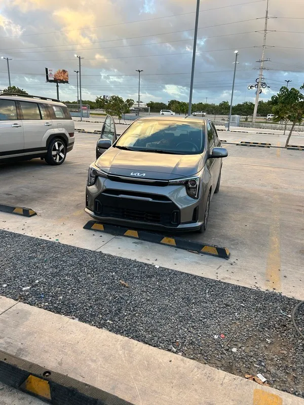 Compact grey Kia waiting for its driver in the airport car park in Punta Cana